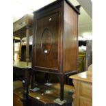 An Edwardian mahogany side cabinet with single panelled door on square tapered legs.