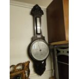 Carved oak framed aneroid wall barometer