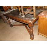 A large French oak parquetry topped rectangular draw leaf dining table with turned legs and cross