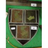A lead light stained glass panel depicting an armorial crest.