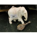 Carved ivory elephant and a miniature lute.