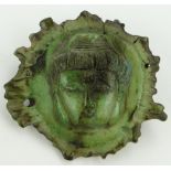 Stags horn amulet 
with carved Buddha's head, 2.25" across.