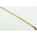 A riding crop with dogs head handle & gold collar,