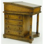 A miniature oak Davenport
with 4 fitted drawers and secret compartment.