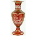 A Bohemian ruby glass vase
with engraved deer in a forest panels 13".