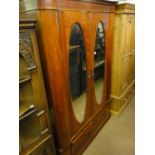 An Edwardian mahogany and satinwood strung 2 door wardrobe with drawer fitted base.