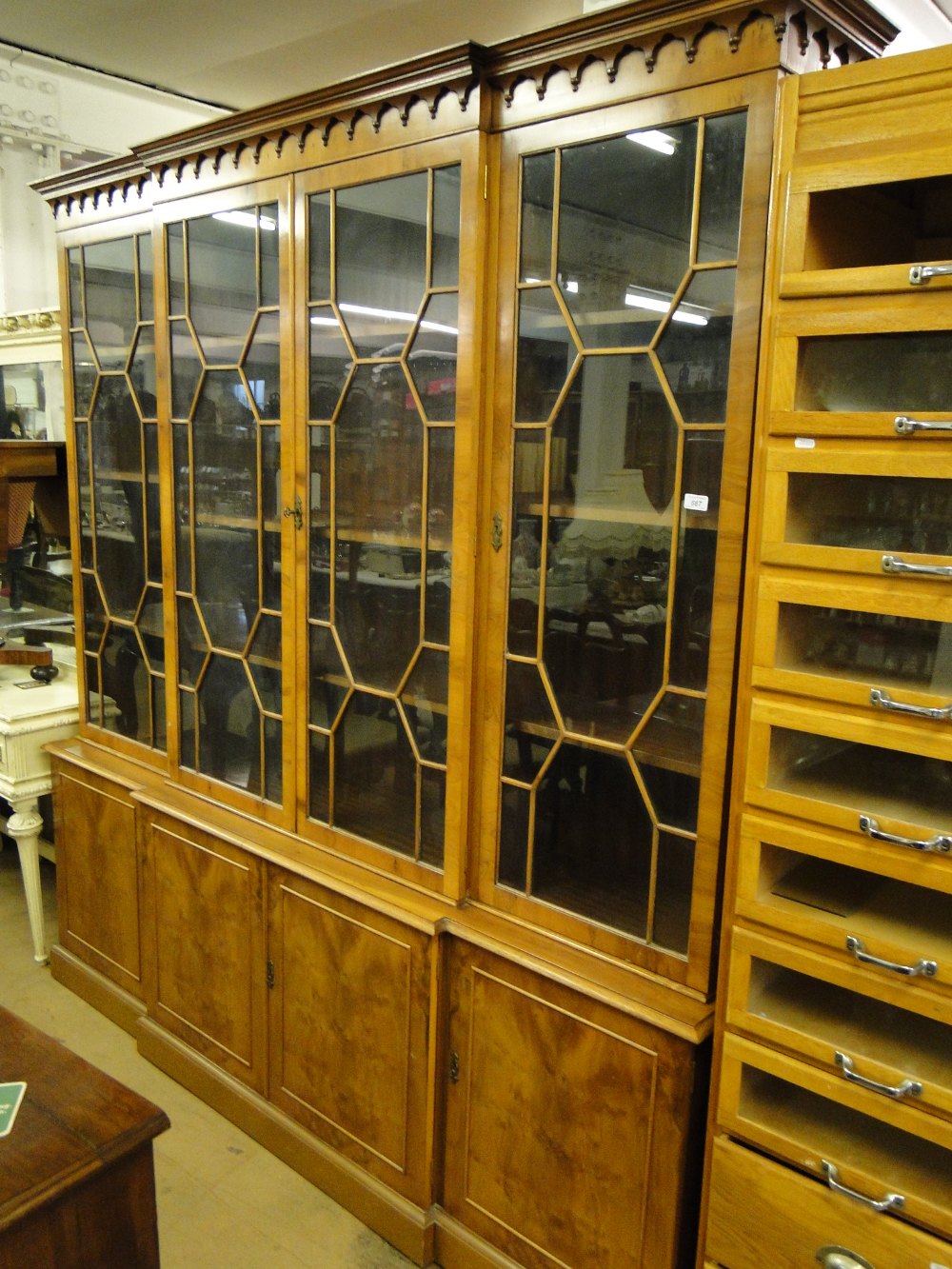 A large reproduction yewwood break front 2-section bookcase,
