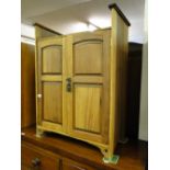 An Arts & Crafts walnut cabinet, with 2 panelled doors.