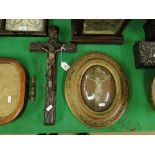 Convexed framed crucifix and another with metal figure.