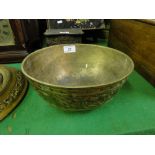 An Oriental brass bowl.