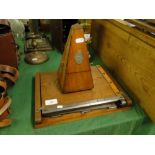 Antique French metronome and an oak guillotine.