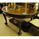 A mahogany oval wind-out dining table,