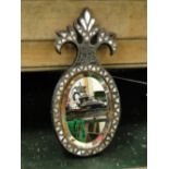 A Middle Eastern mother of pearl inlaid hand mirror.