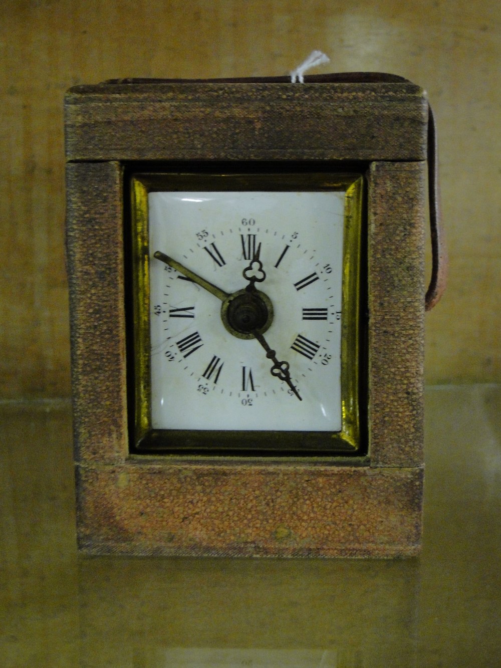 A carriage clock in case.