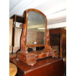 A 19th century mahogany swing toilet mirror with rising lid.