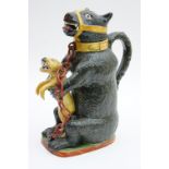 Staffordshire bear baiting jug, circa 1830-50, modelled as a seated, chained bear holding a dog,