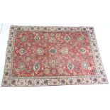 Tabriz woollen carpet, deep red field dispersed with palmettes and with a fawn palmette border,