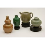 Four Chinese miniatures including a Sung celadon glazed wine vessel, 6cm; small celadon jar,