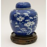 Chinese blue and white prunus pattern ginger jar, 19th Century, on a turned wooden stand,