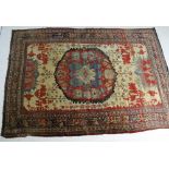 Hamadan woollen carpet, central red medallion against a yellow-fawn ground,