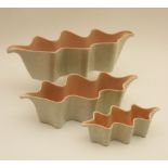 Three Poole clam form flower troughs, each with grey mottled exterior, pink interior,