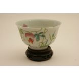 Chinese famille rose bowl, decorated with bursting gua on a vine against a white ground,