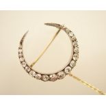 Diamond crescent brooch, set with 21 graduating old brilliant cut diamonds in silver claw mounts,