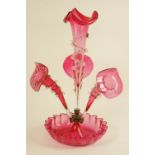 Victorian cranberry glass epergne, having non-matching trumpets over a frilled base, 42.