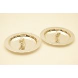 Pair of silver dishes by A E Jones, Birmingham 1971, each of circular form, one centred with a bull,