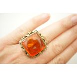 Silver gilt and amber dress ring, cabochon square form amber inset with an insect, 20mm,