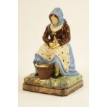 Continental glazed figure of a fish merchant, late 19th Century,