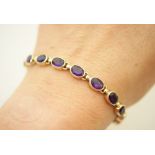 Amethyst bracelet set in 9ct gold, en suite to the previous lot, set with 16 oval cut stones,