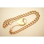 9ct gold graduated curb link bracelet, with safety chain and heart shaped locket, weight approx. 24.