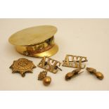 Brass officer's cap snuff box containing a small number of military badges including ASC,