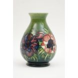 Moorcroft Anemone vase, baluster form with blue and red flowers against a shaded green ground,