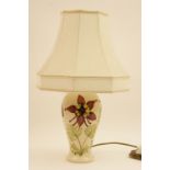 Moorcroft Clematis table lamp, ovoid form decorated with flowers against a white ground,