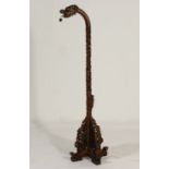 Eastern carved hardwood dragon form standard lamp, carved with dragons flying amidst clouds,