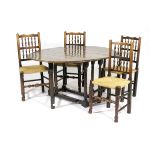 Oak gateleg table and four spindle back dining chairs, the table with oval top with two drop leaves,