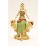 Royal Dux figure modelled as a Grecian water carrier, decorated in green, pink,