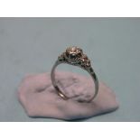 A diamond solitaire ring, approx. 0.65ct., carved claw setting, large, unmarked white metal shank,