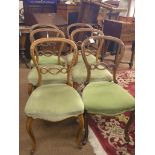 A matched set of six Victorian walnut balloon-back dining chairs, two chairs with applied paper