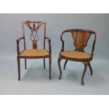 An Edwardian mahogany elbow chair, rounded back with broad marquetry panel in boxwood and holly, and