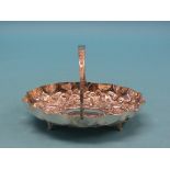 An Edward VII silver bread basket, oval-shape deeply embossed with flowers, leaves and C-scrolls,