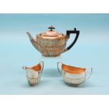 A late Victorian silver teaset, three pieces, oval, half-fluted form, London 1895, approx. 25.5oz.