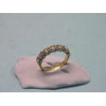 An 18ct. gold and diamond half-hoop ring, seven claw-set diamonds, size L/M