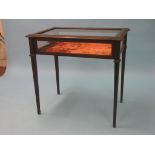 A late Victorian mahogany and brass-inlaid bijouterie, rectangular-shape with bevelled glass