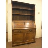 A solid, dark oak bureau bookcase, open bookcase with two adjustable shelves above panelled fall-