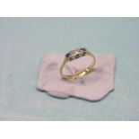 An 18ct. gold half-hoop ring, set central diamond and two sapphires, size L/M