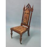A Victorian rosewood gothic drawing room single chair, arched back with carved detail, original