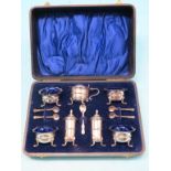 A silver condiment set, consisting of four salts, mustard pot, all with blue glass liners, pair of